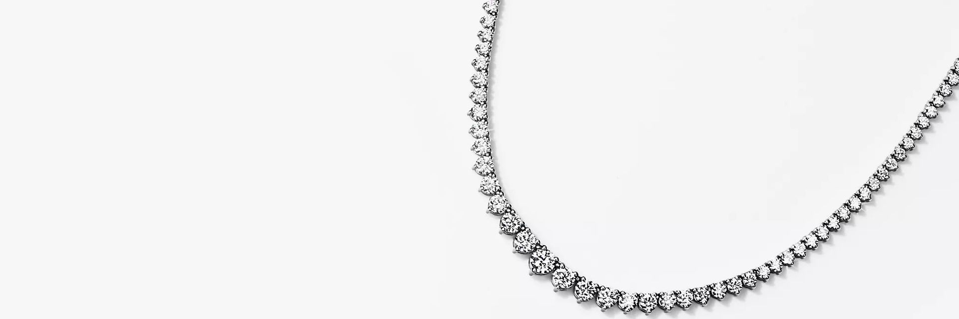 Eternity graduated diamond necklace in 18k white gold.